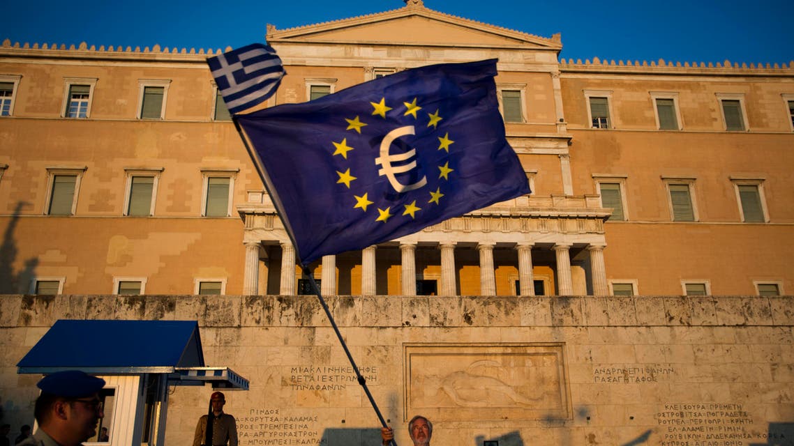 A demonstrator waves a European Union flag in front of the Greek Parliament during a rally in Athens, Thursday, July 9, 2015. Hopes that Greece can get a rescue deal that will prevent a catastrophic exit from the euro rose on Thursday, after key creditors said they were open to discussing how to ease the country's debt load, a long-time sticking point in their talks. (AP Photo/Emilio Morenatti)