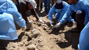 Forensic workers search for the remains of bodies belonging to Shi'ite soldiers from Camp Speicher who were killed by Islamic State militants. (File: Reuters)