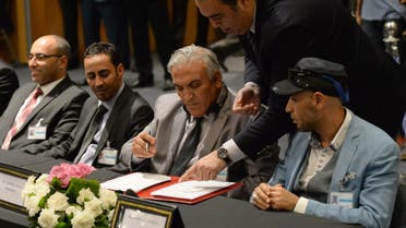 Members of the delegation from the government in the eastern city of Tobruk sign the document on a new version of a U.N.-brokered peace deal. (File: AFP)
