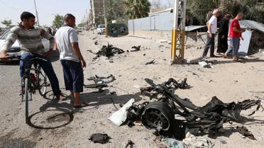Civilians inspect the site of a car bomb attack in Baghdad's northern neighborhood of Shaab, Iraq, Thursday, June 25, 2015. AP
