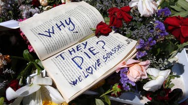 In this Sunday, June 28, 2015 file photo, a book and flowers lay at the scene of the attack in Sousse, Tunisia. Tunisia's state news agency says the country's president is declaring a state of emergency more than a week after a beach attack targeting foreign tourists that killed 38 people. The news agency said President Beji Caid Essebsi would address the nation later Saturday, July 4 after declaring the state of emergency more than a week after the attack in the Tunisian resort of Sousse. (AP Photo/Abdeljalil Bounhar, file)