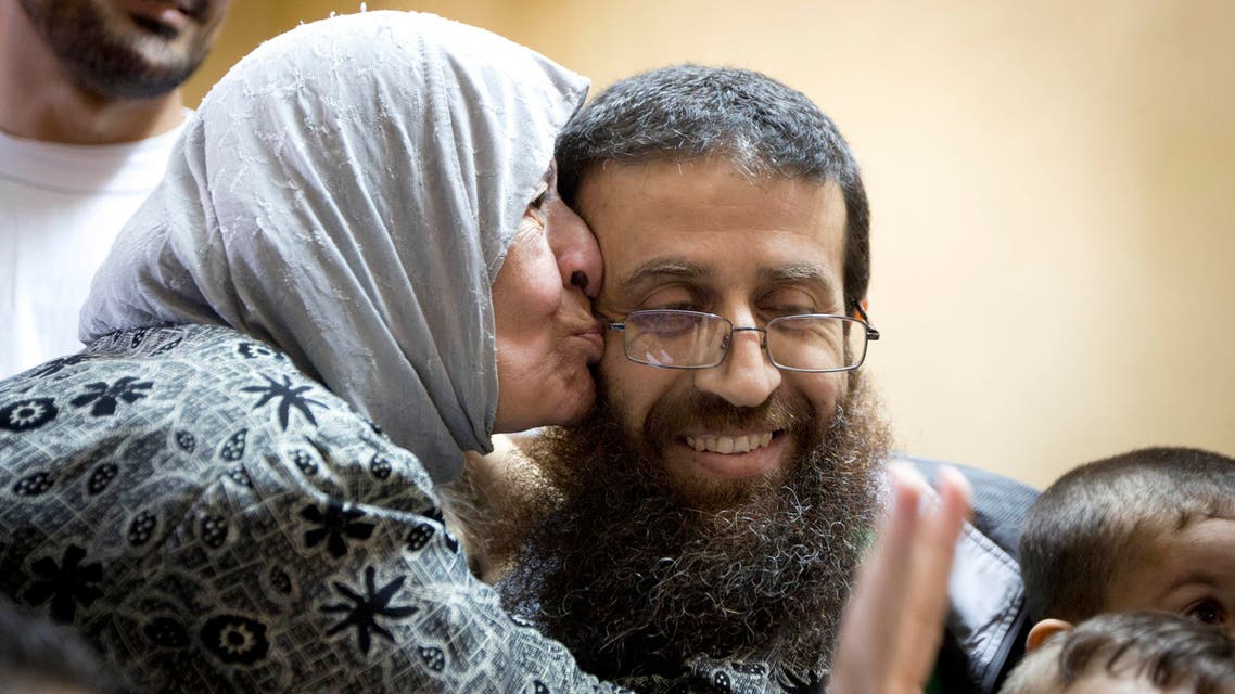Palestinian Khader Adnan is greeted by Palestinians after his release from an Israeli prison in the West Bank village of Arrabeh near Jenin, Sunday, July 12, 2015.AP
