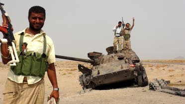Southern Resistance fighters stand with a tank destroyed during fighting against Houthi fighters in the Emran outskirts of Yemen's southern port city of Aden. (Reuters)