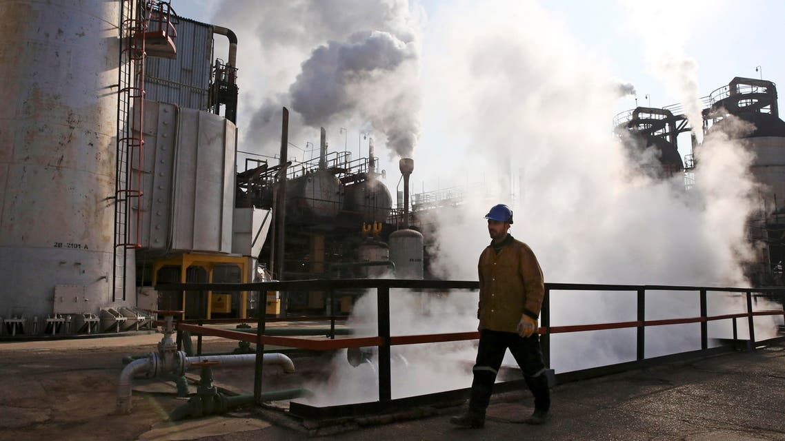 In Monday, Dec. 22, 2014 photo, an Iranian oil worker walks at Tehran's oil refinery south of the capital in Iran. (AP)
