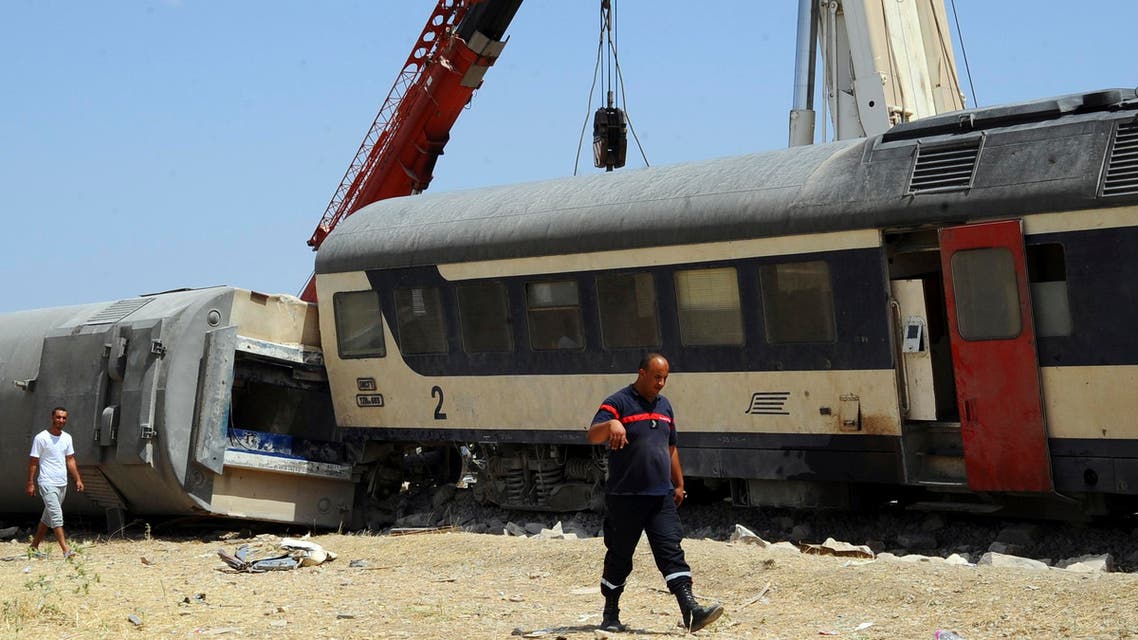 A rescue worker walks past a derailed train outside Fahs, 60 kilometers (37 miles) from Tunis, Tunisia, Tuesday, June 16, 2015 AP