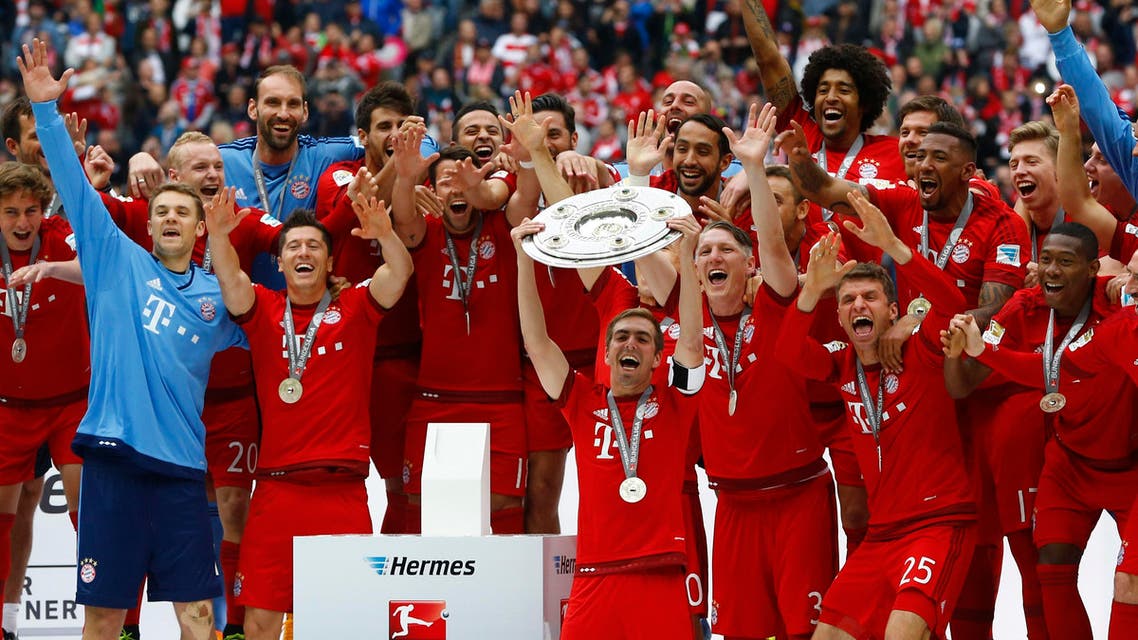 Bayern's Philipp Lahm holds the Bundesliga trophy after the German first division Bundesliga soccer match between FC Bayern Munich and FSV Mainz 05 at the Allianz Arena in Munich, Germany, Saturday, May 23, 2015.AP