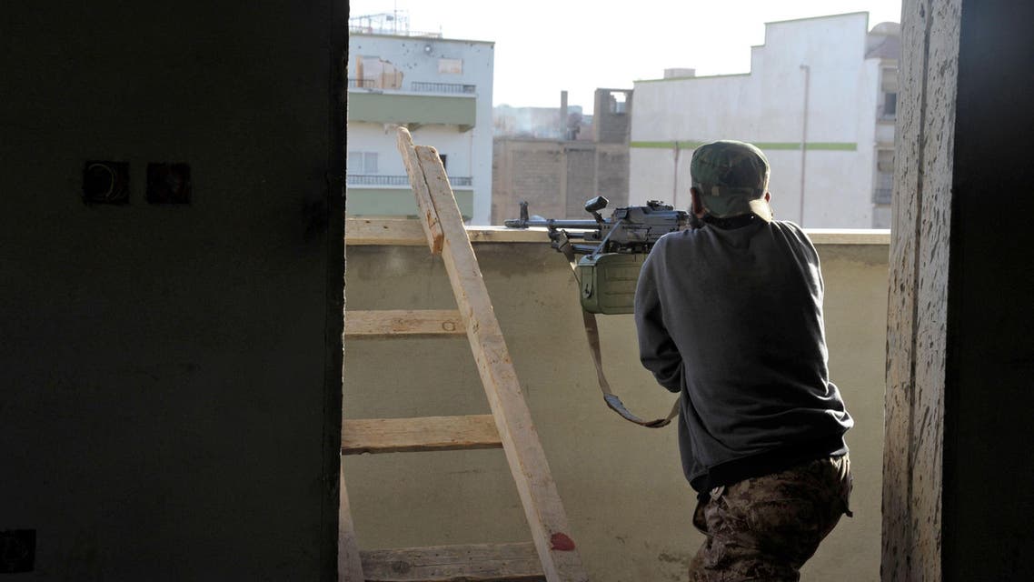 In this Wednesday, Oct. 29, 2014 photo, a Libyan military solider aims his weapon during clashes with Islamic militias in Benghazi, Libya. AP