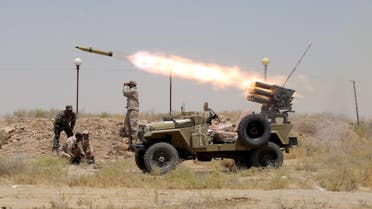 Members of Iraq's Shi'ite paramilitaries launch a rocket towards Islamic State militants in the outskirts of the city of Falluja, in the province of Anbar, Iraq July 12, 2015. REUTERS/Stringer