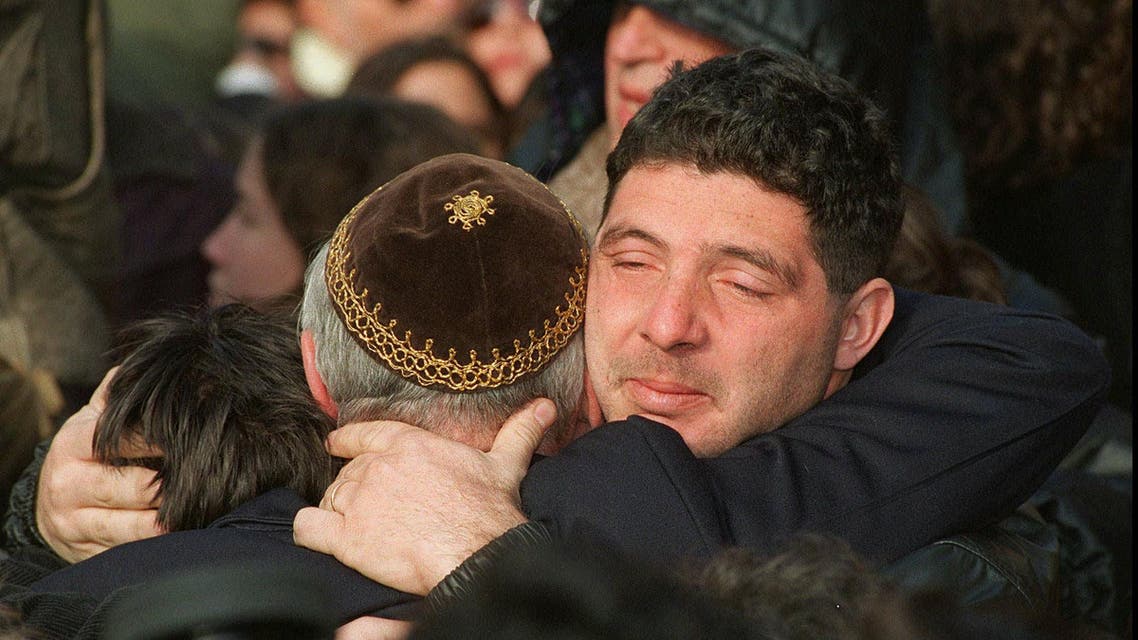 Three members of the Argentine Jewish community embrace during a ceremony Tuesday, July 18, 1995 on the first anniversary of the terrorist attack that destroyed Buenos Aires' Jewish Community Center, killing almost 100 people. One year after the worst peacetime attack on Jews outside Israel, almost 3,000 people gathered in silence opposite the bombed site of what was once a thriving cultural center. (AP Photo/Juan Jose Rojas,La NACION)