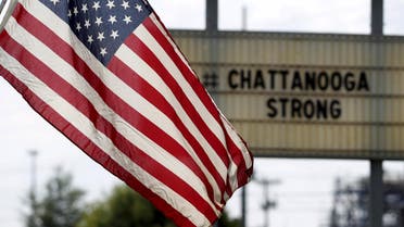 U.S. flag flies alongside a sign in honor of the four Marines killed in Chattanooga, Tennessee July 17, 2015. REUTERS