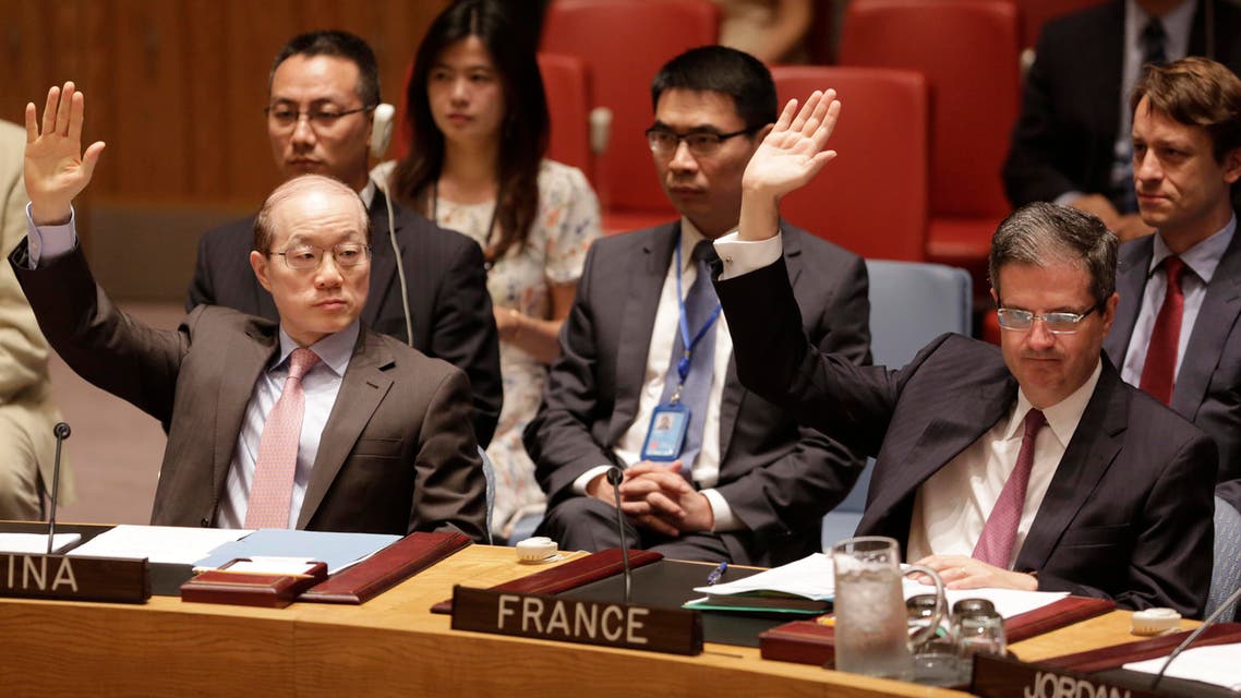 China’s United Nations Ambassador Liu Jieyi, left, and French Ambassador Francois Delattre vote in favor of a Security Council resolution approving Iran's nuclear deal at United Nations headquarters. (AP)