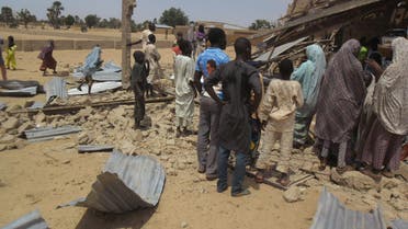 People gather around the Redeemed Christian Church of God, after a bomb blast in Potiskum, Nigeria, Sunday, July 5, 2015. A woman suicide bomber blew up in the midst of a crowded evangelical Christian church service in northeast Nigeria on Sunday and killed at least five people, witnesses said. (AP Photo/Adamu Adamu Damaturu)