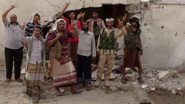 Southern Resistance fighters flash the victory sign at the international airport of Yemen's southern port city of Aden