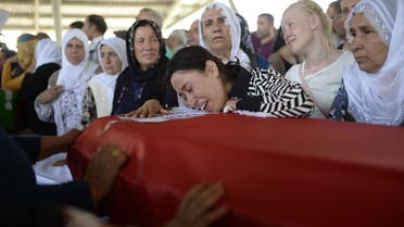  A woman reacts over a coffin as people mourn relatives in Gaziantep on July 21, 2015, AFP 