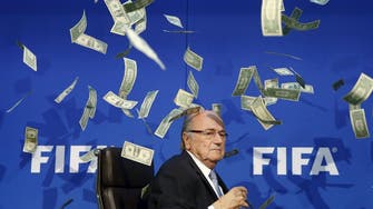Showered in prankster's fake dollars, Blatter makes quick exit