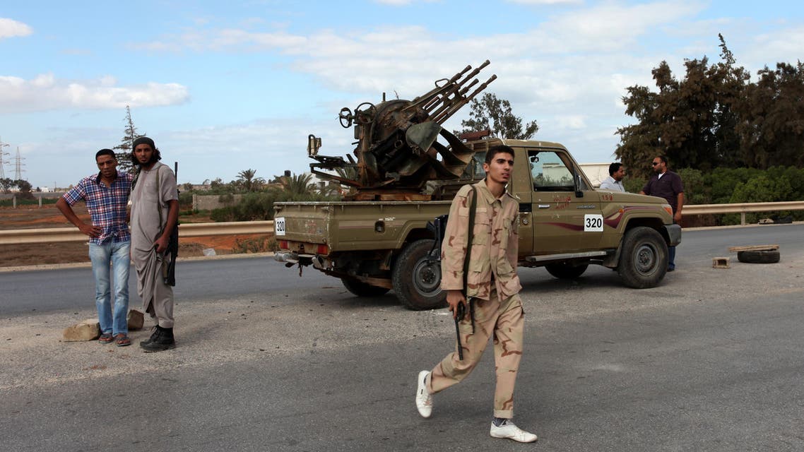 Members of the Rafallah Sahati Islamic Militia Brigades, stand on alert in front their base in Benghazi, Libya, Saturday, Sept. 22, 2012. On Friday evening, hundreds of protesters angry over last week's killing of the U.S. ambassador to Libya stormed the compound of the Islamic extremist Ansar al-Shariah Brigade militia suspected in the attack, evicting militiamen and setting fire to their building. After taking over the Ansar compound, protesters then drove to attack the Benghazi headquarters of Rafallah Sahati where militiamen opened fire on the protesters, who were largely unarmed, leaving at least 20 wounded, and several killed according to hospital sources. (AP Photo/Mohammad Hannon)