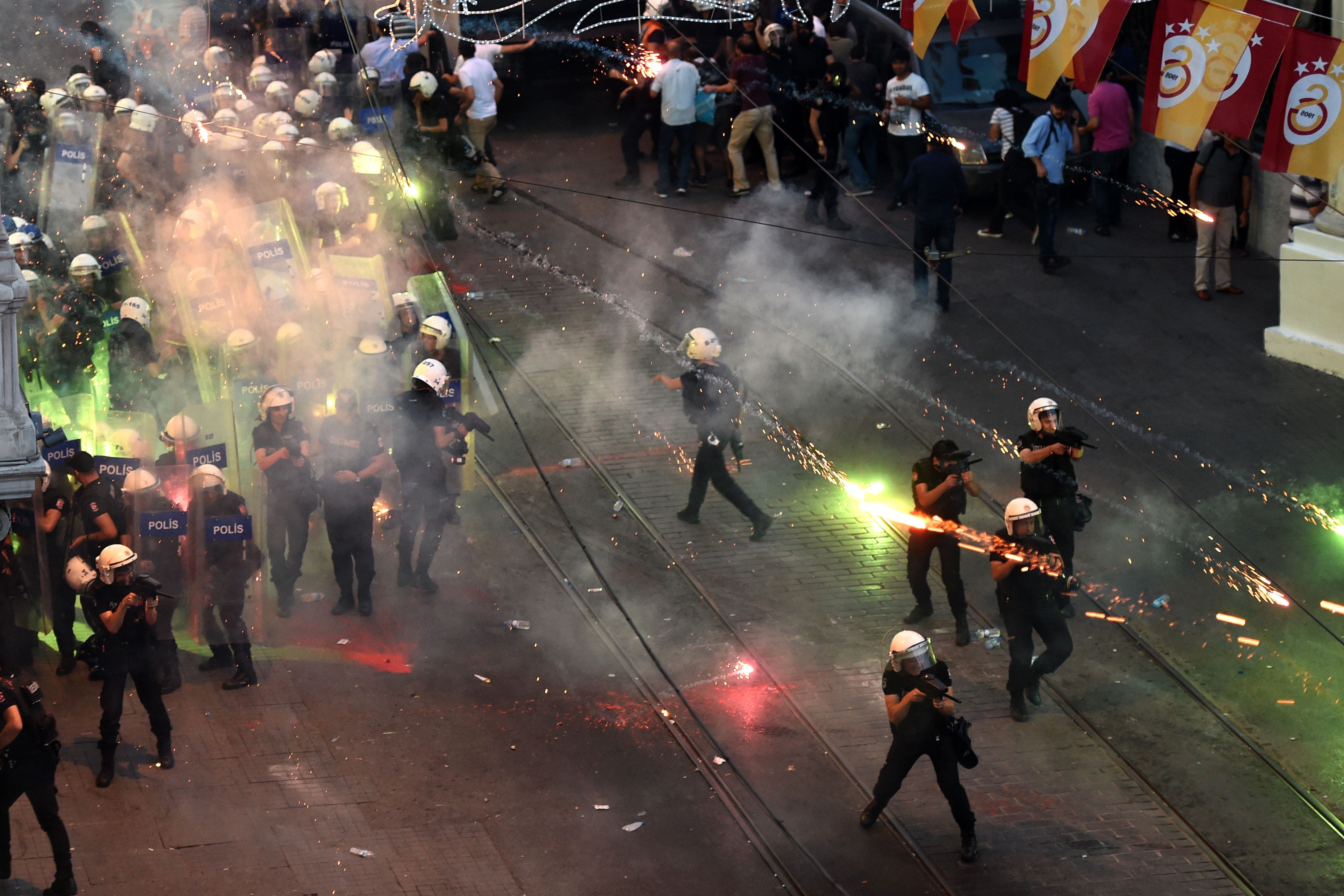 Protestors throw fireworks at Turkish riot policemen firing rubber bullets to disperse them during a demonstration on July 20,2015 in Istanbul AFP