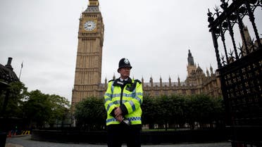 a British police officer stands guard outside the Houses of Parliament in London. The military-style daylight attack on the streets of Paris on Wednesday, Jan. 7, 2015. AP 