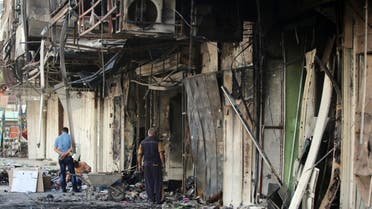    AHR02 - Baghdad, -, IRAQ : Iraqi men stand at the scene of one of two car bomb explosions in Baghdad on July 22, 2015 following late night blasts which killed at least 19 people in mostly Shiite neighbourhoods of the Iraqi capital, according to police. No group has yet claimed last night's blasts, but the Islamic State group (IS) has carried out deadly attacks in Baghdad earlier this month. AFP PHOTO/ AHMAD AL-RUBAYE
