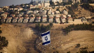 In this Monday, Sept. 7, 2009 file photo, an Israeli flag is seen in front of the West Bank Jewish settlement of Maaleh Adumim, on the outskirts of Jerusalem. AP 