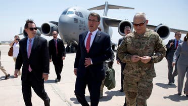 U.S. Defense Secretary Ash Carter, center, is greeted by U.S. Ambassador to Iraq Stu Jones, left, and Army Lt. Gen. James Terry, right, as he arrives at Baghdad International Airport in Baghdad, Iraq, Thursday, July 23, 2015. 