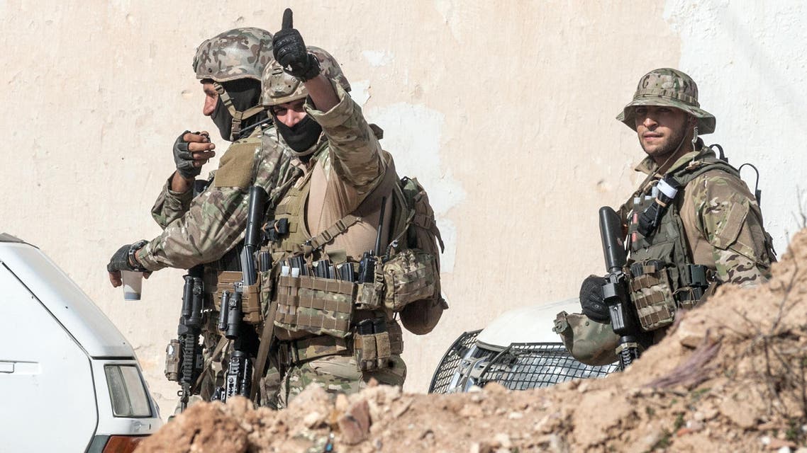 A Tunisian soldier gives a thumbs up to celebrate the end of a raid against gunmen in the Oued Ellil suburb of Tunis, Tunisia, Friday, Oct. 24, 2014. AP