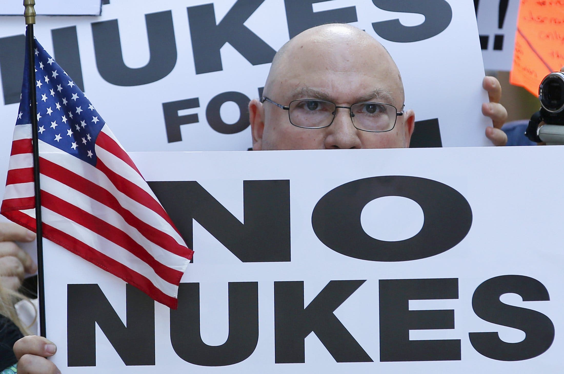 A man holds up a sign as he and several thousand other protestors demonstrate during a rally apposing the nuclear deal with Iran in Times Square in the Manhattan borough of New York. Reuters 