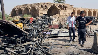 Civilians inspect the scene of a deadly Friday night suicide car bombing at a busy market in Khan Beni Saad, about 20 miles (30 kilometers) northeast of Baghdad, Iraq, Saturday, July 18, 2015. AP