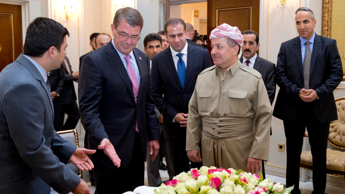 U.S. Defense Secretary Ash Carter gestures to the guest book he just signed as he stand with Iraqi Kurdistan Regional President Massoud Barzani at the White House in Irbil, Iraq, Friday, July 24, 2015. AP