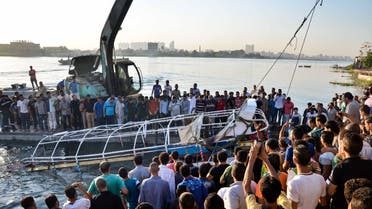 Egyptians look at the passenger boat that sunk in the river Nile in Giza, south of Cairo, Egypt, Thursday, July 23, 2015. AP