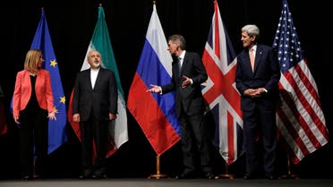 British Foreign Secretary Philip Hammond, 2nd right, U.S. Secretary of State John Kerry, right, and European Union High Representative for Foreign Affairs and Security Policy Federica Mogherini, left, talk to Iranian Foreign Minister Mohammad Javad Zarif as the wait for Russian Foreign Minister Sergey Lavrov, not pictured, for a group picture at the Vienna International Center in Vienna, Austria, Tuesday, July 14, 2015. After 18 days of intense and often fractious negotiation, world powers and Iran struck a landmark deal Tuesday to curb Iran's nuclear program in exchange for billions of dollars in relief from international sanctions — an agreement designed to avert the threat of a nuclear-armed Iran and another U.S. military intervention in the Muslim world. (Carlos Barria, Pool Photo via AP)