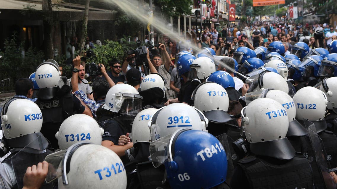 AA12 - Ankara, Ankara, TURKEY : Turkish police officers spray tear gas during a protest condemning a suicide bombing, that killed 32 activists on July 20 in the Turkish border town of Suruc, on July 25, 2015 in Ankara. Turkey's military on July 25 carried out a new wave of air and artillery strikes against Islamic State (IS) jihadists in Syria and Kurdish militants in northern Iraq, in an escalating campaign Ankara says is aimed at rooting out terror. The two-pronged operation against IS and the outlawed Kurdistan Workers Party (PKK) -- two groups who are themselves bitterly opposed -- came after a week of deadly violence in Turkey the authorities blamed on both organisations. Violence in Turkey erupted after the killing of 32 people in a suicide bombing on July 20 in the Turkish town of Suruc on the Syrian border carried out by a 20-year old Turkish man linked to IS. AFP PHOTO / ADEM ALTAN