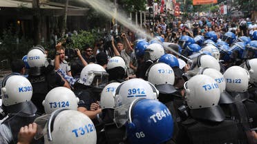    AA12 - Ankara, Ankara, TURKEY : Turkish police officers spray tear gas during a protest condemning a suicide bombing, that killed 32 activists on July 20 in the Turkish border town of Suruc, on July 25, 2015 in Ankara. Turkey's military on July 25 carried out a new wave of air and artillery strikes against Islamic State (IS) jihadists in Syria and Kurdish militants in northern Iraq, in an escalating campaign Ankara says is aimed at rooting out terror. The two-pronged operation against IS and the outlawed Kurdistan Workers Party (PKK) -- two groups who are themselves bitterly opposed -- came after a week of deadly violence in Turkey the authorities blamed on both organisations. Violence in Turkey erupted after the killing of 32 people in a suicide bombing on July 20 in the Turkish town of Suruc on the Syrian border carried out by a 20-year old Turkish man linked to IS. AFP PHOTO / ADEM ALTAN
