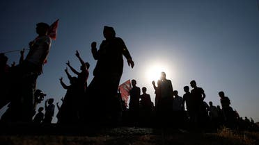 Family members and friends of Osman Cicek, 24, and Kasim Deprem, 21, two of Monday explosion victims, in Suruc, southeastern Turkey, near the border with Syria, walk during their funeral procession, Tuesday, July 21, 2015.