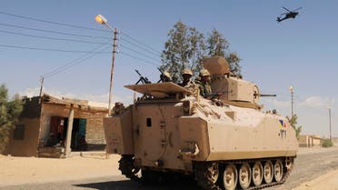  In this Tuesday, May 12, 2013 file photo, Egyptian Army soldiers patrol in an armored vehicle backed by a helicopter gunship during a sweep through villages in Sheikh Zuweyid, north Sinai, Egypt. AP 