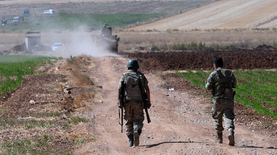 Turkish soldiers patrol near the border with Syria, ouside the village of Elbeyli, east of the town of Kilis, southeastern Turkey, Friday, July 24, 2015. AP Turkish soldiers backs