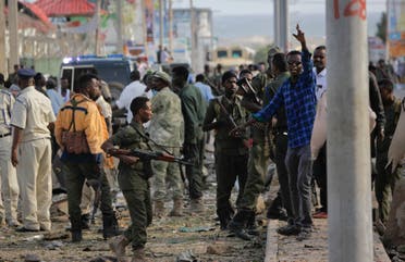 Security forces gather at the scene following a suicide car bomb attack in the capital Mogadishu, Somalia, Sunday, July 26, 2015. (AP)