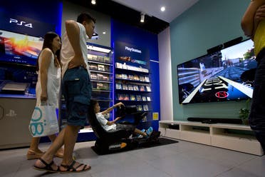 A child tries out a video game at a shop in Beijing, Monday, July 27, 2015. China is lifting its ban on sales of video game consoles to promote the industry and a new manufacturing zone in Shanghai. (AP)