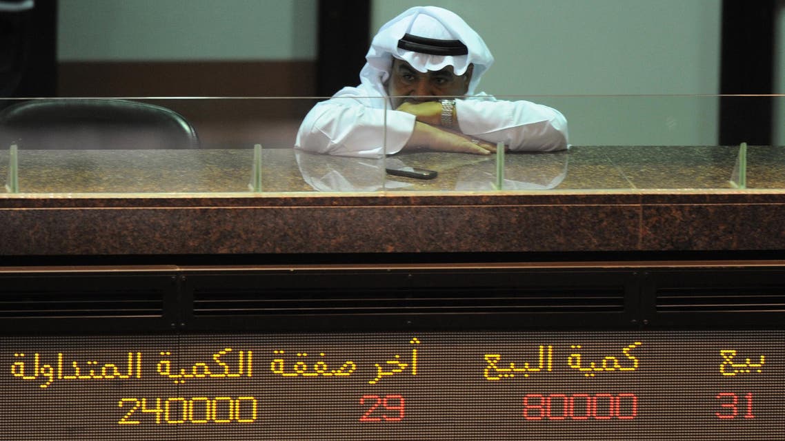 A Kuwaiti trader follows the downturn of shares at Kuwait Stock Exchange in Kuwait City Monday, July 18, 2011. The KSE Market Index on Monday closed 1.57% lower at 5,973.1 points. As the debt clock is ticking in Europe and the US, financials dragged the bourse down. National Bank of Kuwait (NBK) dived 5.76% to KD1.040. Gulf Bank of Kuwait declined 3.8% to KD0.500. Sokouk Holding surged 14.3% and closed as a top gainer at KD0.020. (AP Photo/Gustavo Ferrari)