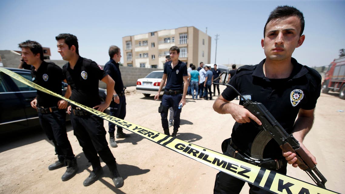 A police officer patrols as Turkish police raid homes in the Haci Bayram neighborhood of the capital Ankara, Turkey, Monday, July 27, 2015. AP