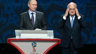 FIFA President Sepp Blatter, right, adjusts his glasses during a speech by Russian President Vladimir Putin during the preliminary draw for the 2018 soccer World Cup in Konstantin Palace in St. Petersburg, Russia, Saturday, July 25, 2015. (AP Photo/Ivan Sekretarev)