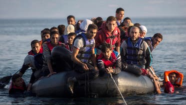  Migrants from Syria and Afghanistan arrive on an overcrowded dinghy from the Turkish coasts to the Greek island of Lesbos, Monday, July 27, 2015. Nearly 50,000 people have illegally entered the country this year, mostly Syrian refugees who risk the sea crossing from Turkey in dangerous, overcrowded boats. From Greece, most try to continue north through the Balkans to more affluent European countries such as Germany. (AP Photo/Santi Palacios)