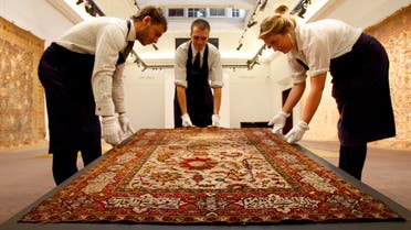  A Safavid silk, wool and metal thread prayer rug is displayed at Sotheby's auction rooms in London, Friday, Oct. 2, 2009. The rug, estimated at 80,000- 120,000 pounds (US$127,943-US$191,915) is one of the items for auction in the Arts of the Islamic World sale on Oct. 7, 2009. (AP Photo/Kirsty Wigglesworth)
