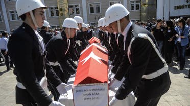    -04 - Sanliurfa, Sanliurfa, TURKEY : Turkish police officers lift the coffins of two police officers during their funeral on July 23, 2015, in Sanliurfa, after they were found shot dead at their home in the Turkish town of Ceylanpinar on the border with Syria. The military wing of the outlawed Kurdistan Workers' Party (PKK) said on July 22 it had killed the two Turkish police officers as a reprisal for a suicide bombing blamed on Islamic State jihadists, that killed 32 activists near the Syrian border. AFP PHOTO / BULENT KILIC
