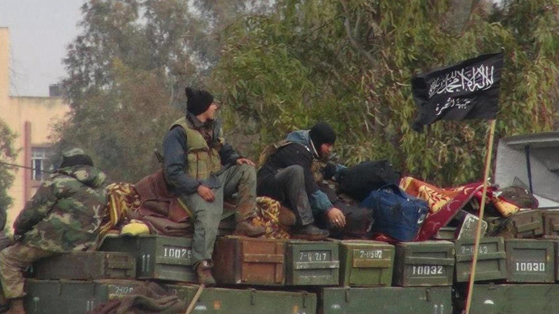 In this Friday, Jan. 11, 2013 file photo, citizen journalism image provided by an anti-Bashar Assad activist group Edlib News Network (ENN), which has been authenticated based on its contents and other AP reporting, rebels from al-Qaida-affiliated Jabhat al-Nusra, also known as the Nusra Front, sit on a truck full of ammunition at Taftanaz air base, that was captured by the rebels in Idlib province, northern Syria. The Nusra Front, Syria's al-Qaida affiliate, is consolidating power in territory stretching from the Turkish border to central and southern Syria, crushing moderate opponents and forcibly converting minorities using tactics akin to its ultraconservative rival, the Islamic State group. (AP Photo/Edlib News Network ENN, File)