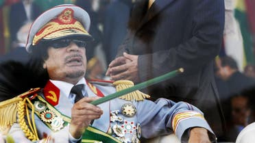 ap In this Tuesday, Sept. 1, 2009 file photo, Libyan leader Moammar Gadhafi gestures with a green cane as he takes his seat behind bulletproof glass for a military parade in Green Square, Tripoli, Libya.