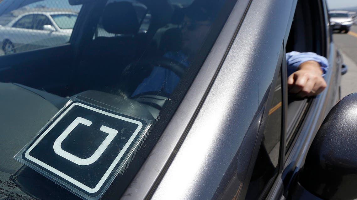  Uber driver Karim Amrani sits in his car parked near the San Francisco International Airport parking area in San Francisco, Wednesday, July 15, 2015. In the three months ended in June, Uber overtook taxis as the most expensed form of ground transportation, according to expense management system provider Certify. (AP Photo/Jeff Chiu)