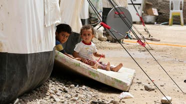 Iraqis children play outside a tent at a camp for displaced people in the al-Shurta neighborhood of west Baghdad, Iraq, Saturday, June 20, 2015. (AP)