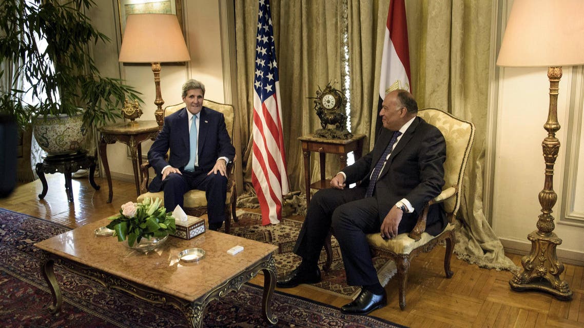 U.S. Secretary of State John Kerry speaks with Egyptian Foreign Minister Sameh Shukri before a meeting at the Ministry of Foreign Affairs in Cairo