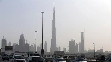 Cars pass by the city skyline with the Burj Khalifa, world tallest tower in background, Tuesday, July 28, 2015, in Dubai, United Arab Emirates. (AP)